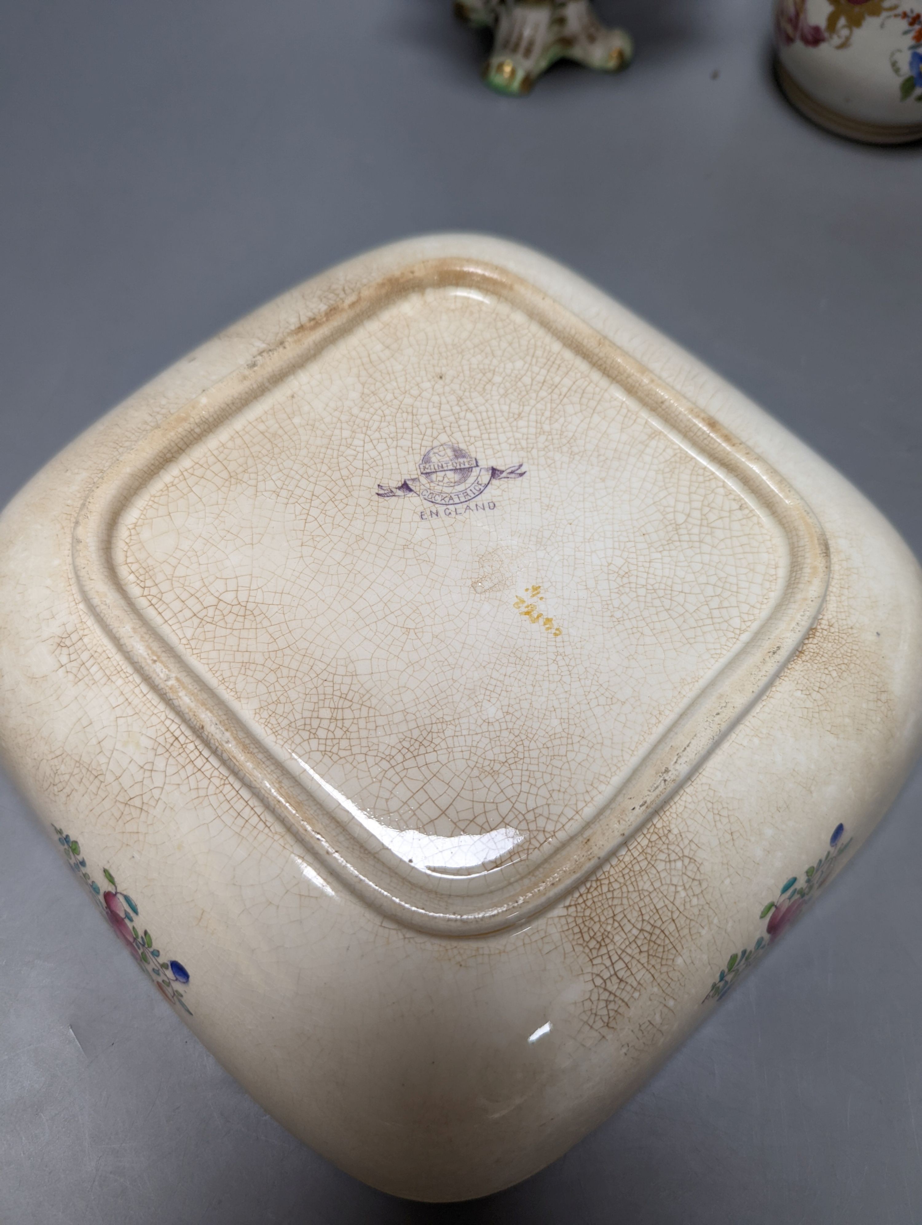 A Meissen style chocolate cup and cover, two mid 19th century English porcelain flower encrusted pots and covers and two dishes